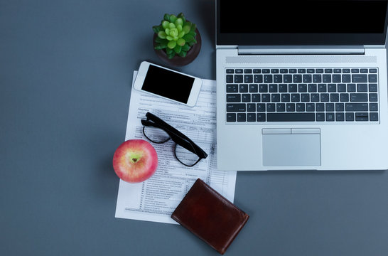 Gray office desktop with modern technology for doing financial tax