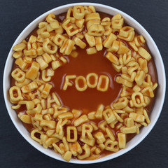 Overhead photo of letter spaghetti in a white round bowl, spells FOOD