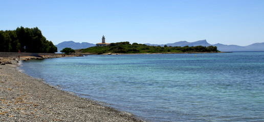 Alcanada beach and little island with lighthouse at the back
