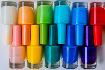 colored nail polishes on a white background