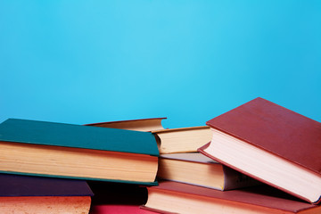 Fototapeta premium Stack of books isolated on blue background.
