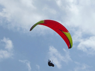 Paraglider flying wing in a blue sky	
