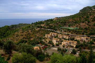 Fototapeta na wymiar Aereal view of Deia town and mediterranean sea at the back