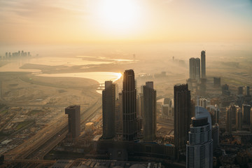 Beautiful sunrise above Dubai skyline, United Arab Emirates, aerial panoramic view from Burj Khalifa.