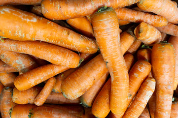 A lot of carrots are in a drawer in the store