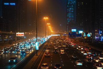 Evening rush hour with many cars on Dubai city road at night, traffic jam in downtown.