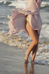 Girl on the seashore in a summer dress, vacation by the sea.