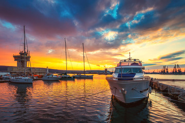 Yacht port and beautiful sunset over Varna, Bulgaria. Sailboat harbor, many beautiful moored sail...