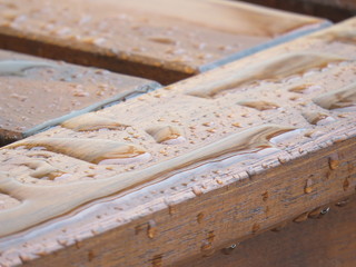 Water over wood bench - closeup