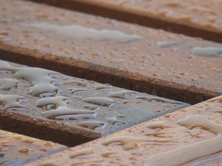 Water over wood bench - closeup