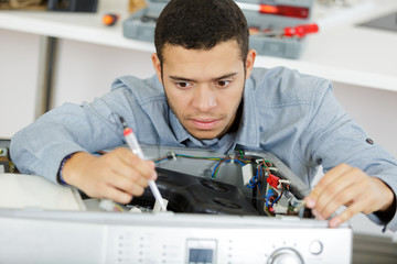 plumber fixing domestic washing machine