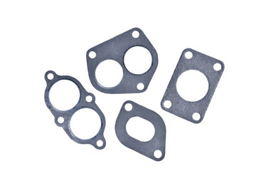 gasket set of automotive paronite exhaust and intake manifold with metal inserts and auto parts on a white background