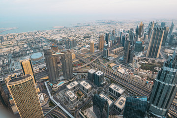 Dubai skyline panorama from above. Futuristic skyscrapers, office buildings and road junctions. Business district and city downtown in morning.