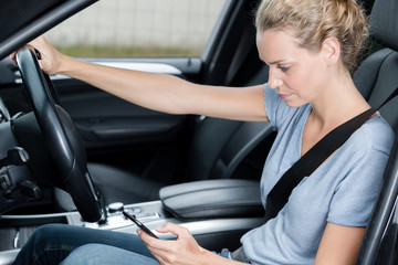 woman driver use her cell phone driving car