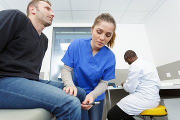 Fototapeta premium the neurologist testing knee reflex on a patient
