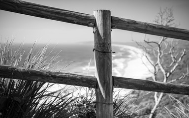 Black and white photo of a fence by the sea, Byron Bay Australia