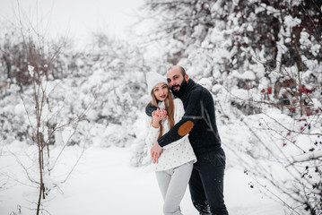 Couple playing with snow in the forest