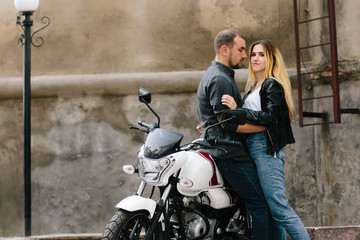 Naklejka na ściany i meble Couple on motorbike near old building