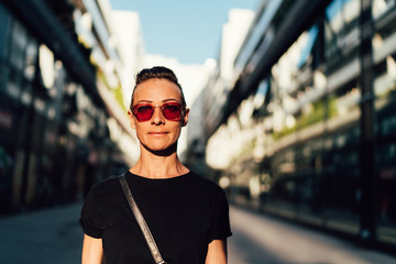 Portrait of woman standing between buildings