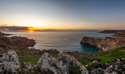 Sunset over a bay on the western coast of Malta, Europe