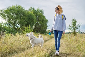 Friendship girls and dogs, teenager and pet husky walking outdoor
