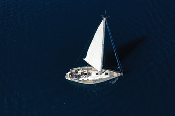 Aerial drone photo of beautiful sail boat cruising in deep blue open ocean sea