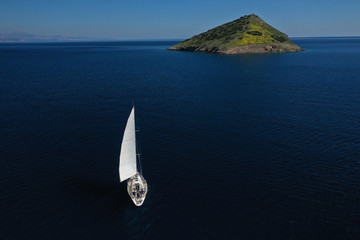 Aerial drone photo of beautiful sail boat near Raftis island as seen at spring, Attica, Greece