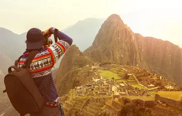 Photo sur Plexiglas Machu Picchu An adventurous photographer taking shots of Machu Picchu - Peru