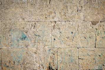 wall of yellow rectangular stones with cement