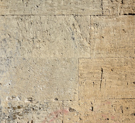wall of yellow rectangular stones with cement