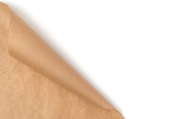 curved edge of a brown parchment paper sheet is isolated on a white background