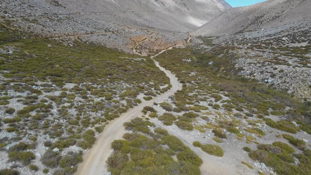 An aerial view inside Andes mountains at Limari Valley, south Atacama. An amazing wild scenery. Arid idyllic valleys with green farm fields feed in by the river at the bottom of the valley
