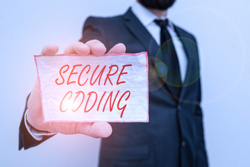 Writing note showing Secure Coding. Business concept for Applied to avoid the introduction of security vulnerabilities Male human wear formal work suit with office look hold book