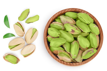 peeled pistachio in wooden bowl isolated on white background with clipping path and full depth of field. Top view. Flat lay