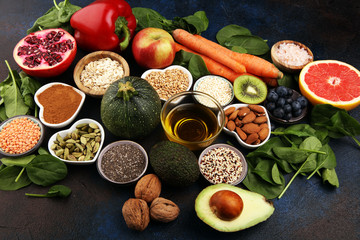 Obraz na płótnie Canvas Healthy food clean eating selection: fruit, vegetable, seeds, superfood, cereals, leaf vegetable on rustic background