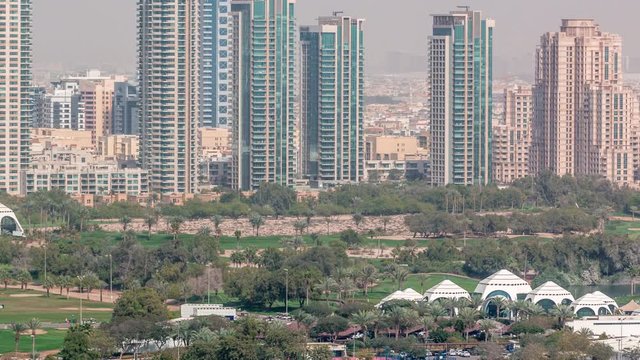 Dubai Golf Course with a cityscape of Gereens and tecom districts at the background aerial timelapse. Top view from Dubai marina