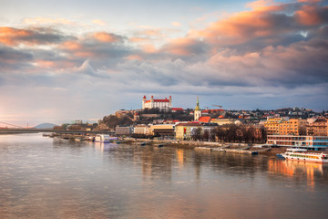 Fototapeta premium Cityscape of Bratislava, Slovakia at Sunset as Seen from a Bridge over Danube River Towards Old Town of Bratislava.