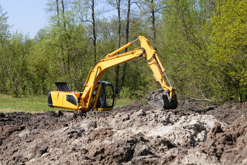 Big industrial excavator working on swamp at sunny day