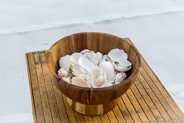 Wooden bowl of seashells 