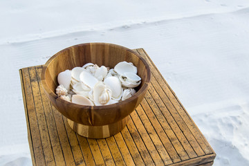 Wooden bowl of seashells 