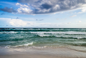 Fototapeta na wymiar Graceful waves flowing onto the shore