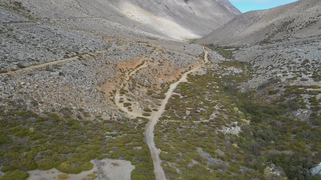 A reverse flight view inside Andes mountains at Limari Valley, south Atacama. An amazing wild scenery. Arid idyllic valleys with green farm fields feed in by the river at the bottom of the valley
