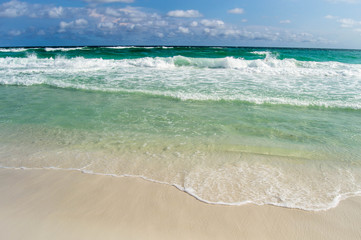 Turquoise waters flowing over the shore