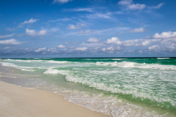 Turquoise waves rolling onto shore