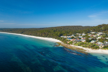 Aerial view of Hyams Beach, known for its vibrant white sand, at Jervis Bay on the New South Wales South Coast, Australia, known for its vibrant white sand looking over residential area on a sunny day