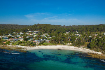 Aerial view of Hyams Beach, known for its vibrant white sand, at Jervis Bay on the New South Wales South Coast, Australia, known for its vibrant white sand looking over residential area on a sunny day