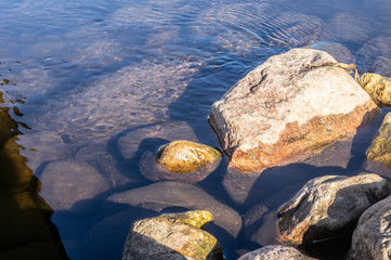 Stones at the bottom of a transparent mountain river