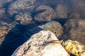 Stones at the bottom of a transparent mountain river