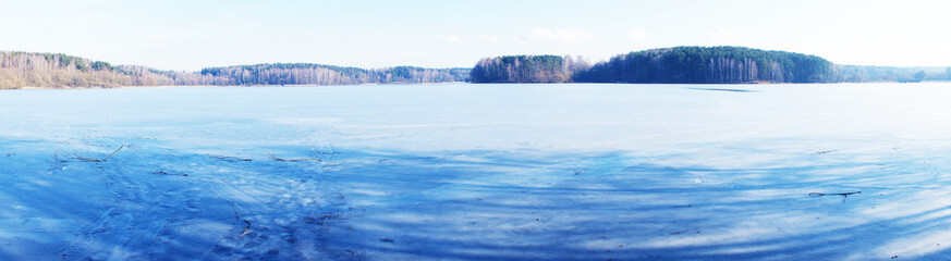 Naklejka na ściany i meble Winter landscape view of a frozen ice lake