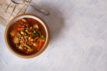Bowl of ground beef soup with vegetables. Healthy food. Flat lay copy space horizontal image